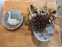 Front view showing both ceramic pieces and floral contents