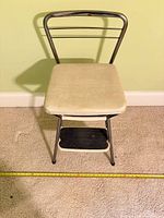 Front view of stool chair showing seat and one step