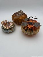 Three glass pumpkins grouped