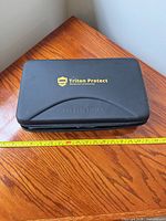 Closed black Triton Protect case with logo