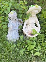 Both garden statues among foliage