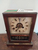 Front view of mantel clock showing dial and case