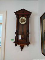 full frontal view of wall clock hanging on wall