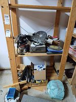 Overall lot on shelving showing router, Routermate base, discs, clamps, sharpener, hand tools