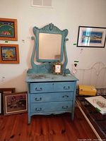 Front view of blue dresser with attached mirror