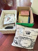 Box and basket containing assorted books plus decorative pillow