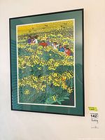 Full view of framed floral and figure print on wall with lot sticker visible