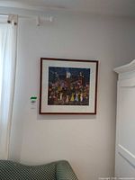 Full view of framed print on wall above couch