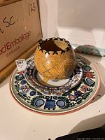 Stacked decorative plates with gourd bowl displayed on top