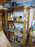 Full view of shelving with multiple paint, stain, filler and plant food containers