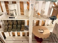 Overall lot on shelving with coffee maker, corbels, vise, wooden disc, hardware