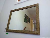 Full view of mirror hanging on wall