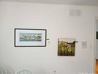 Both framed prints on wall, showing relative sizes and frames