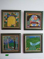 All four framed paintings displayed together