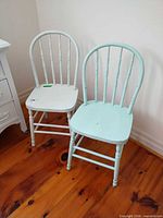 Two chairs, one white one mint, full view