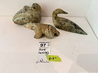Overall view of three soapstone animal carvings: bear, seal, bird with size tag