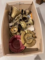 Box view showing mixed brass items and ceramic ashtray