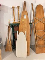 Full view of wooden ironing board with cover in front