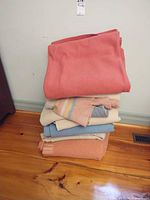 Stack of five wool blankets in assorted colors