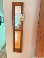 Front view of full mirror hanging on wall