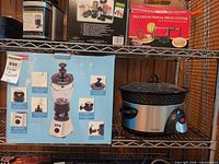 Overall view of boxed Back to Basics blender set beside Crock-Pot digital slow cooker on shelf