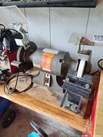Front view of Busy Bee SL-150 bench grinder with accessories attached