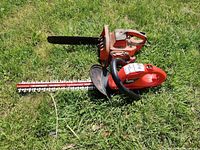 Both tools lying on grass, showing general view