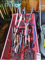 Top view of entire lot in wagon showing loppers, saw, hand tools and garden fork