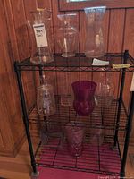 Group of glass vases on shelving unit