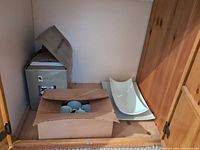Boxed GlucksteinHome dinnerware, cardboard box of cups, two white serving platters