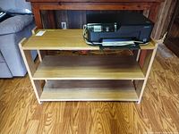 Front view showing entire three-shelf console table