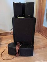 Front view showing subwoofer, three satellites, wrapped speaker wire