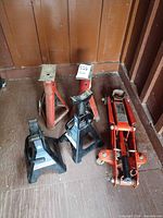 Group shot showing hydraulic floor jack and four jack stands
