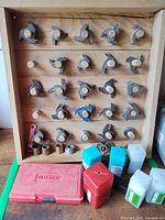 Full view of wood board holding cutters, accessories and cases