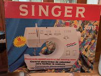 Front of box with model number and image of sewing machine