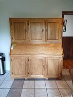 Front view of solid oak hutch secretary showing overall form and doors