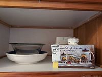 Shelf view showing ceramic bowl, glass bowl, boxed Tre Ci porcelain set, heart-shaped trinket jar