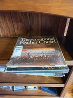 Stack of LP records on shelf showing multiple titles