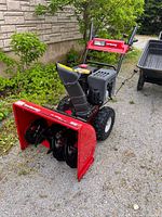 Front angle showing auger housing, chute, handles
