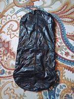 Front view of black leather garment bag closed