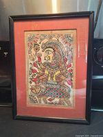 Full framed view of the painting showing black frame and terracotta mat