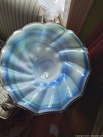 Top view showing ruffled rim and blue/green swirl pattern