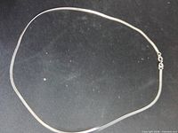 Entire necklace laid flat to show overall length and style