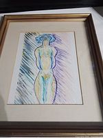 Full view of framed artwork showing gold frame, cream mat, and complete image