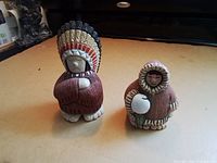 Both Launa figurines standing side by side