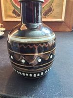 Front view showing overall shape, glaze, slip-dot and chevron decoration