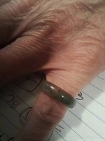 Ring on finger showing translucency and color