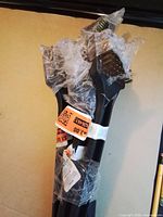 Bundle of six grill brushes wrapped in plastic, wire bristle heads visible