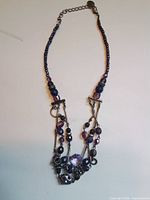 Full view of necklace showing multi-strand layout and extender chain