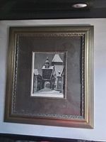 Full view of framed etching on wall showing frame style and matting